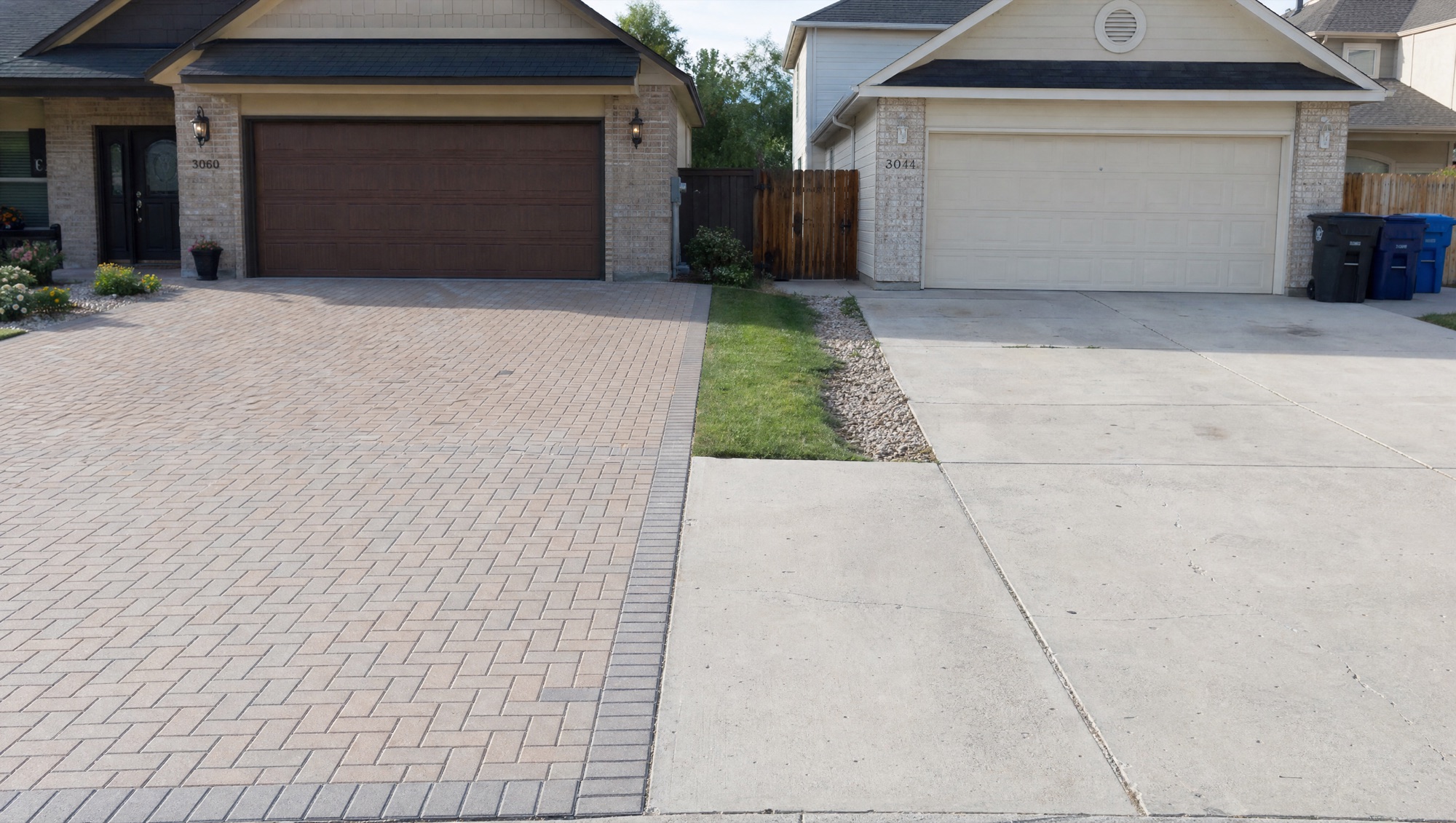 A herringbone paver driveway next to a plain poured-concrete driveway, shown side by side