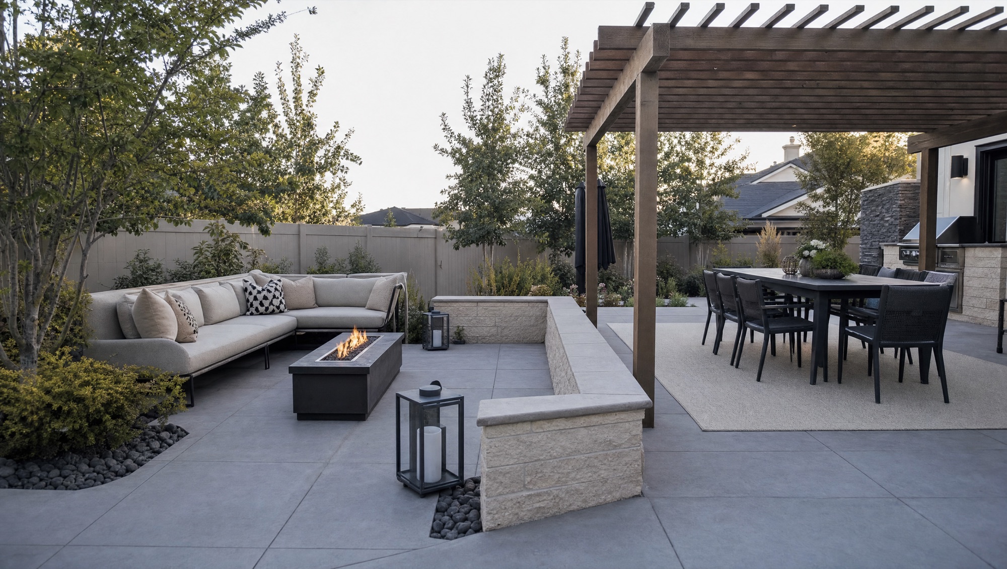 Contemporary zoned backyard with a large-format paver patio, linear fire feature, and pergola dining area